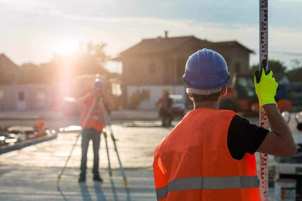 Surveyor using a construction level on a job site