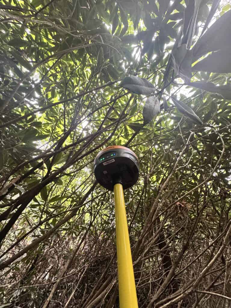 The Hemisphere S631 RTK receiver under tree canopy while surveying.