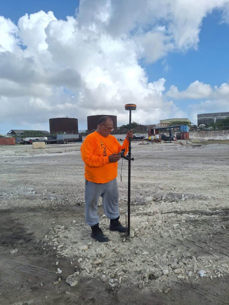 Surveyor using Network RTK equipment on a construction site