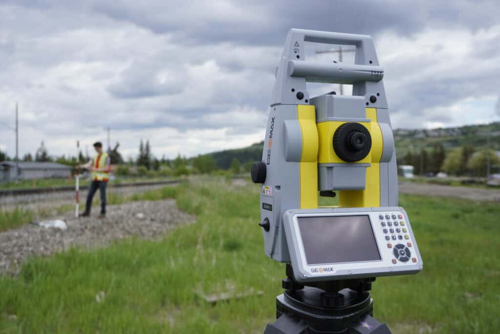 Surveyor operating GeoMax Zoom 90 Robotic Total Station.