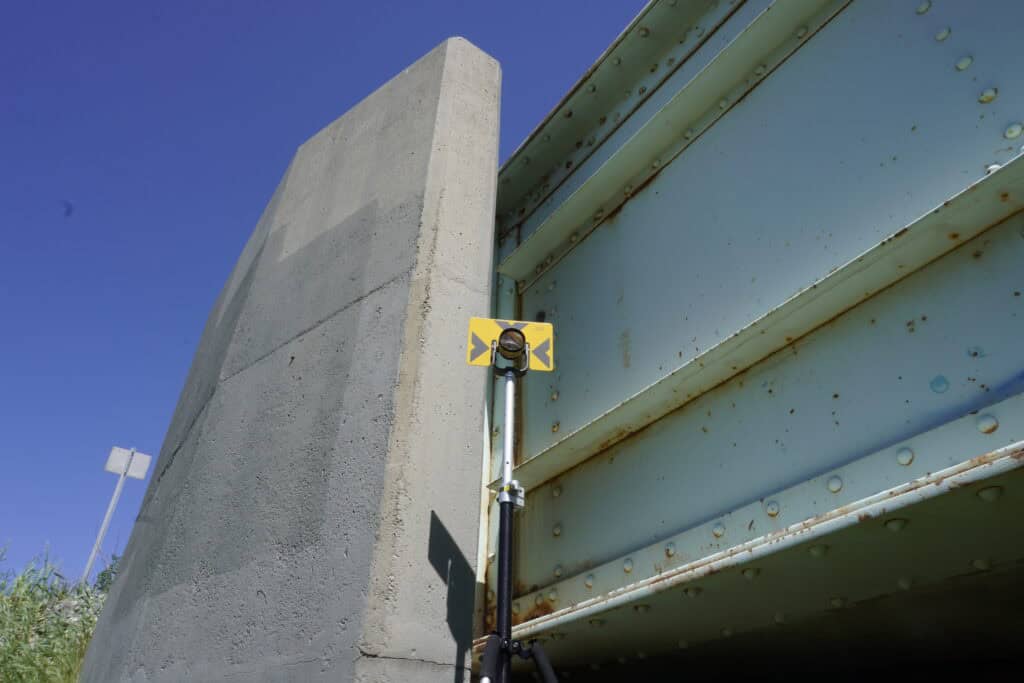 Mini prism setup on concrete structure for precision land surveying
