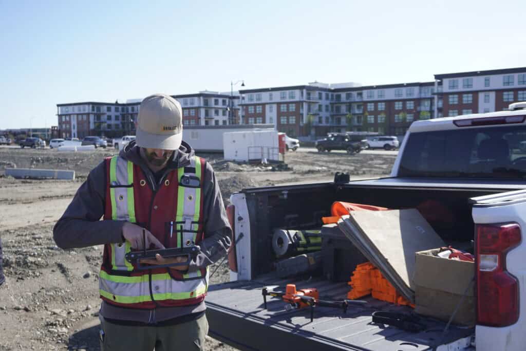 UAV drone capturing topographic survey data for large construction site mapping