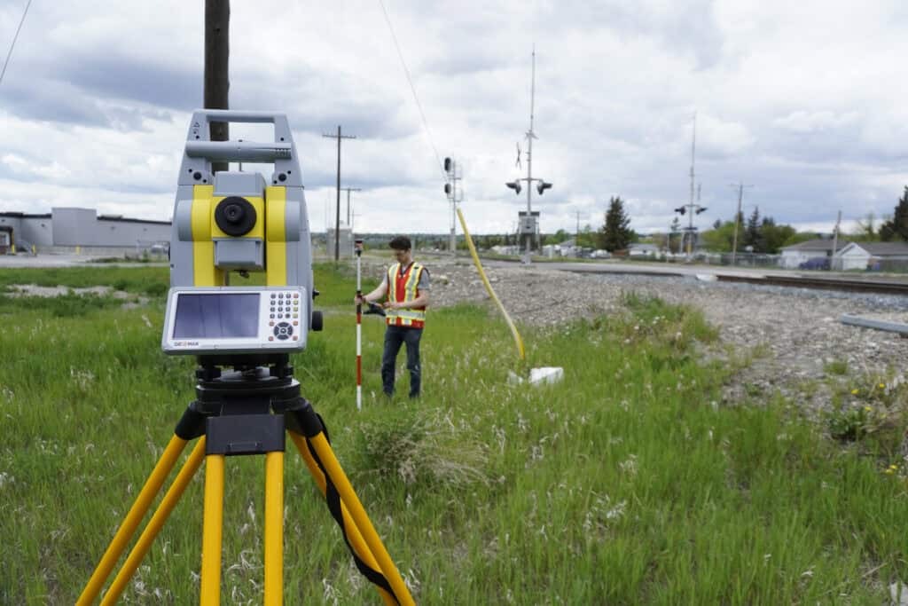 Total station mounted on a surveying tripod at a rail survey site
